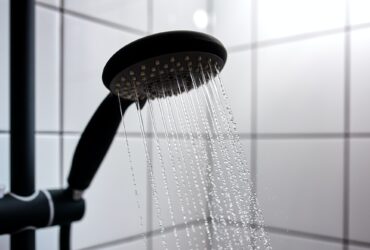 Water from the shower in the modern bathroom
