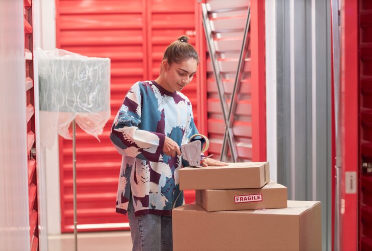 Woman Taping Boxes In Self Storage 2023 11 27 05 20 07 Utc