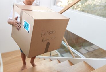 Hispanic Boy Carrying Box Into New Home On Moving 2023 11 27 05 17 28 Utc