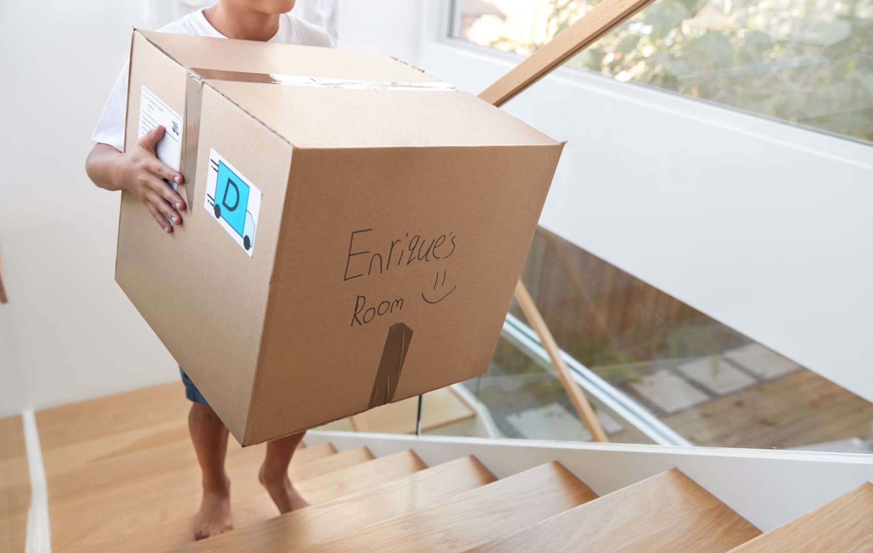 Hispanic Boy Carrying Box Into New Home On Moving 2023 11 27 05 17 28 Utc