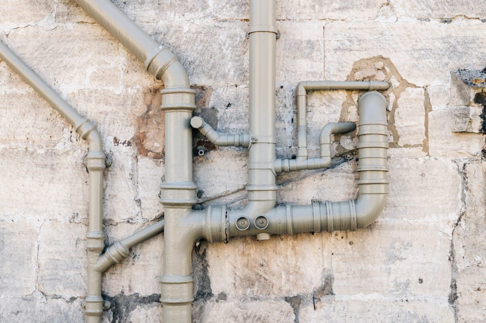 Iron Sewer Pipes On Stone Wall Background 2023 11 27 05 23 58 Utc