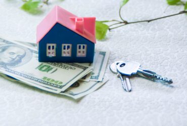 Model House Stands Next To Green Trees Dollars An 2023 11 27 05 06 28 Utc