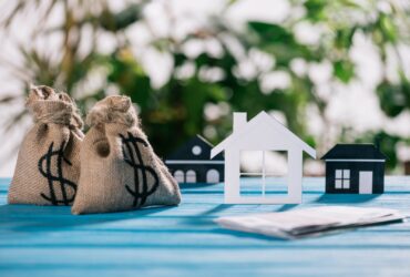 Selective Focus Of Paper Houses And Moneybags With 2023 11 27 05 10 56 Utc
