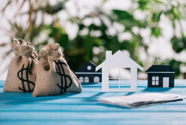 Selective Focus Of Paper Houses And Moneybags With 2023 11 27 05 10 56 Utc