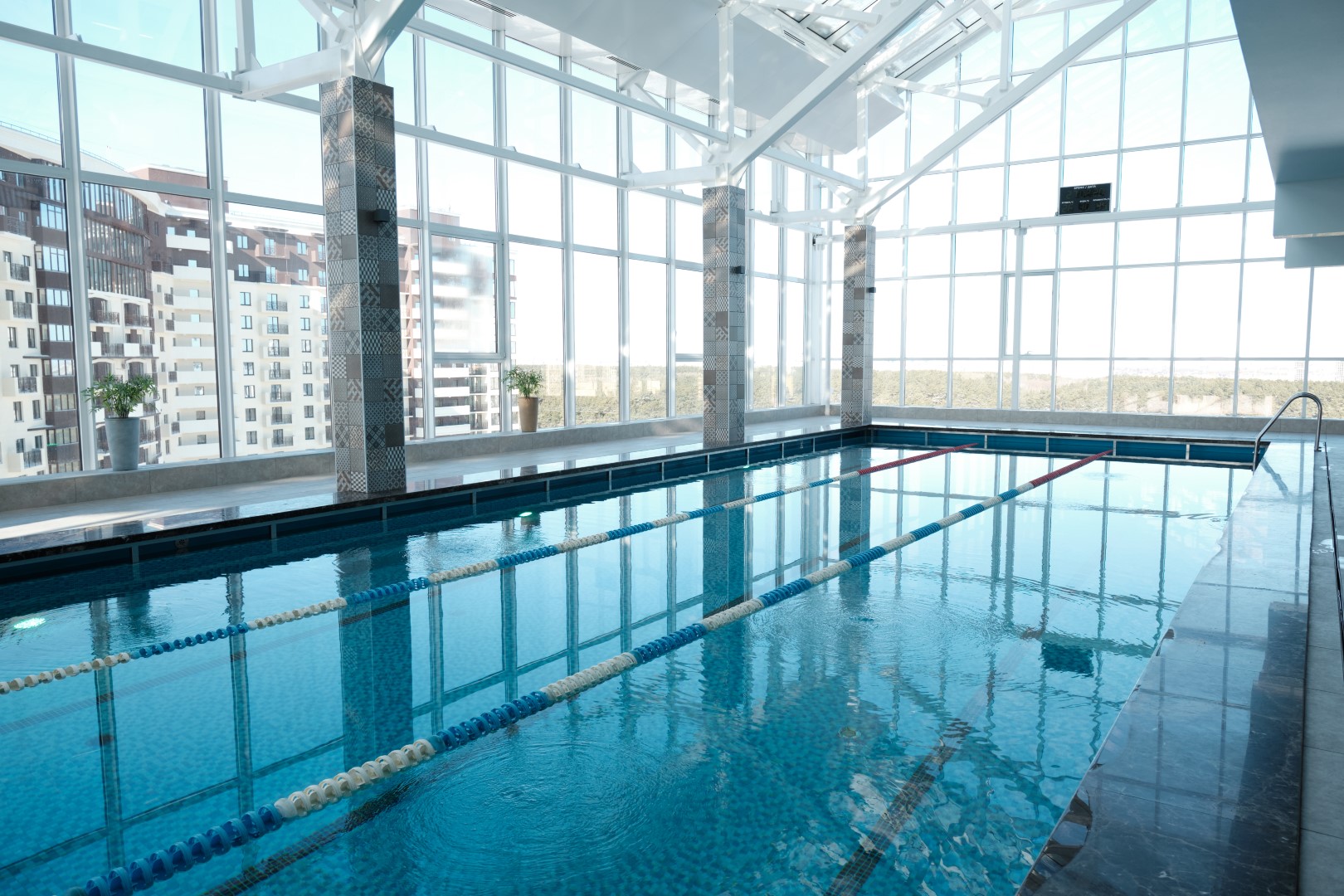 A glass extension that has a swimming pool in it