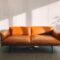 2-seat Orange Leather Sofa Beside Wall