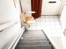 Automatic Stair Lift On Staircase Taking Elderly People And Disabled Persons Up And Down In A House