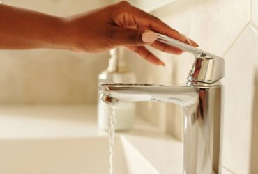 Person Holding a Faucet