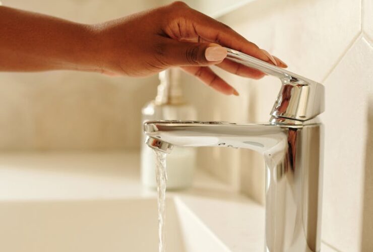 Person Holding a Faucet