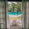 brown wooden table near swimming pool