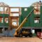 yellow and black heavy equipment near unfinished building