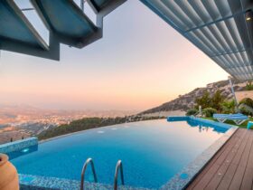 Infinity pool with breathtaking mountain and city views, perfect for a luxury tropical getaway.