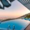 Infinity pool with breathtaking mountain and city views, perfect for a luxury tropical getaway.