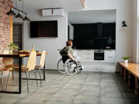 photo of woman on wheelchair going to the kitchen