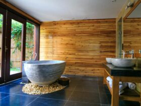 Elegant bathroom showcasing a modern marble tub and wooden interior for a serene escape.