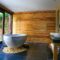 Elegant bathroom showcasing a modern marble tub and wooden interior for a serene escape.