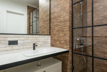 A clean and contemporary bathroom featuring a stylish shower and sleek fixtures.