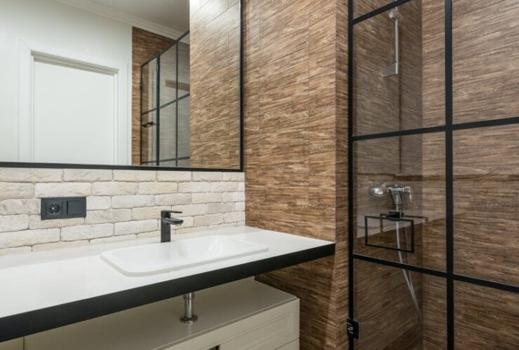 A clean and contemporary bathroom featuring a stylish shower and sleek fixtures.