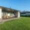 A modern house with a wide patio and neatly landscaped backyard, ideal for real estate and architecture themes.