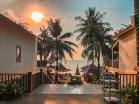 Beautiful sunset over palm-lined beach at Phu Quoc resort, Vietnam, capturing a serene and tropical atmosphere.