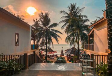 Beautiful sunset over palm-lined beach at Phu Quoc resort, Vietnam, capturing a serene and tropical atmosphere.