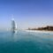 Iconic Burj Al Arab overlooking the pristine Dubai beach, perfect for travel and leisure.