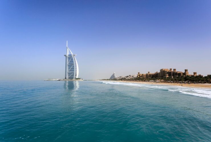Iconic Burj Al Arab overlooking the pristine Dubai beach, perfect for travel and leisure.