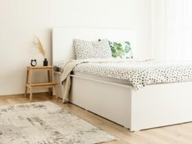 Elegant scandinavian-style bedroom with polka dot bedding and natural decor elements.