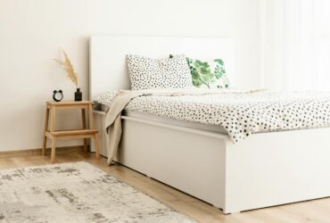 Elegant scandinavian-style bedroom with polka dot bedding and natural decor elements.