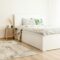 Elegant scandinavian-style bedroom with polka dot bedding and natural decor elements.