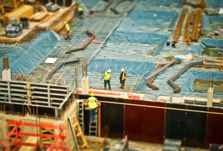 High-angle view of construction workers on a building site, engaging in construction work.