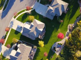 A picturesque aerial view showcasing suburban homes with vibrant gardens and tree-lined streets.