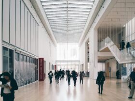 Spacious art gallery lobby with visitors in a modern architectural setting.