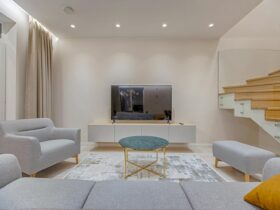 Stylish minimalist living room with modern furniture and warm lighting.