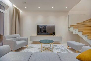 Stylish minimalist living room with modern furniture and warm lighting.