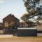 Charming view of a historic building near Lake Overholser Dam, Oklahoma City, with clear skies and lush greenery.