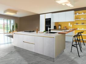 Sleek and modern kitchen interior featuring a large island and open shelving in a contemporary setting.