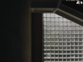 Dramatic staircase with industrial design and textured glass block windows.