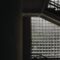 Dramatic staircase with industrial design and textured glass block windows.