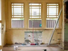 An empty room featuring large windows, ready for renovation in Sydney, Australia.