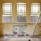 An empty room featuring large windows, ready for renovation in Sydney, Australia.