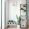 Bright, modern interior with minimal decor, featuring lush houseplants, shelving, and natural light.