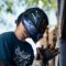 A skilled welder working outside, producing sparks. Shows focus and safety.