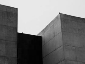 Minimalist black and white photo of brutalist concrete buildings with clean lines.