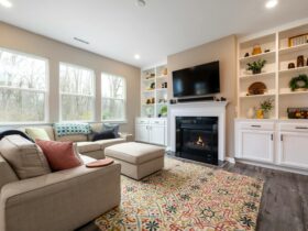 Inviting living area featuring a fireplace, modern decor, and large glass windows.