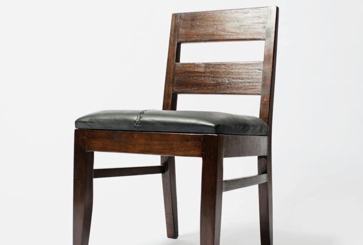 Elegant minimalist wooden chair with leather seat, perfect for modern interiors.