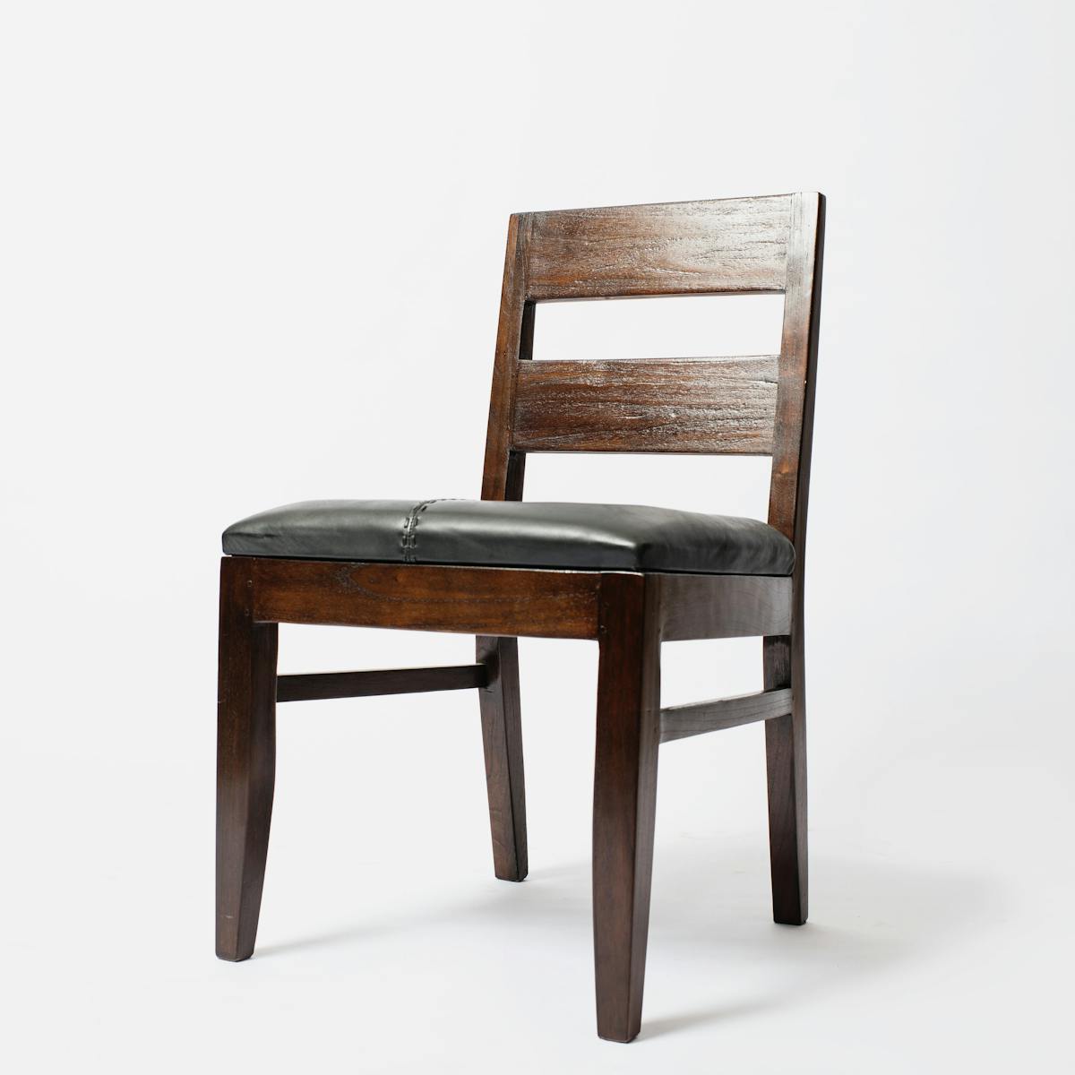 Elegant minimalist wooden chair with leather seat, perfect for modern interiors.