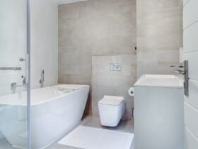 Elegant minimalistic bathroom featuring bathtub and sleek fixtures.