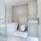 Elegant minimalistic bathroom featuring bathtub and sleek fixtures.