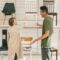 A couple explores chair options together in a modern furniture store during the day.